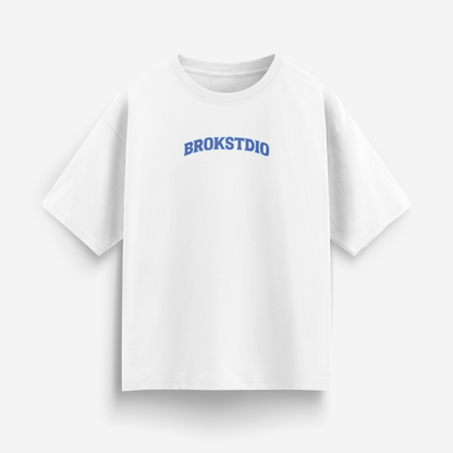 White oversized t-shirt with small arched BROKSTDIO logo in blue on the front